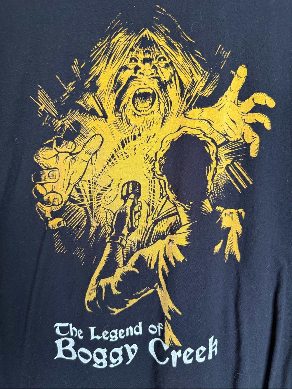 The Legend of Boggy Creek Graphic T‑Shirt — Black with Yellow Print